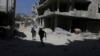 FILE - Fighters from the Free Syrian Army's Al Rahman legion run to avoid snipers on the frontline against the forces of Syria's President Bashar al-Assad in Jobar, a suburb of Damascus, Syria July 27, 2015.