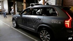 An Uber driverless car is displayed in a garage in San Francisco, Dec. 13, 2016. Uber announced Dec. 22, 2016, it is moving its self-driving cars to Arizona.