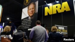 People sign up at the booth for the National Rifle Association at the Conservative Political Action Conference at National Harbor, Maryland, Feb. 23, 2018.