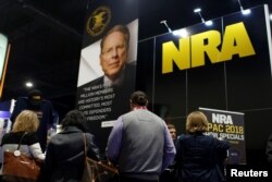 People sign up at the booth for the National Rifle Association at the Conservative Political Action Conference at National Harbor, Maryland, Feb. 23, 2018.