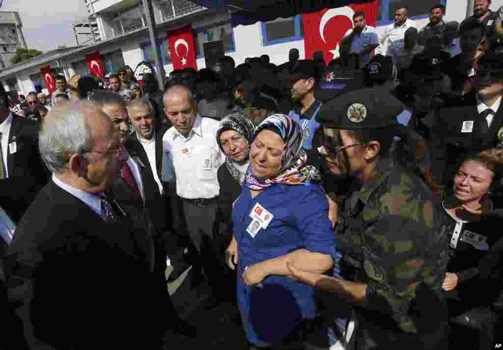 The leader of Turkey&#39;s main opposition Republican People&#39;s Party (CHP) Kemal Kilicdaroglu (left) pays his condolences to Hulya Aydin, the mother of Turkish police special operations officer Sahin Polat Aydin, one of the four officers killed Monday in a landmine attack,&nbsp; Ankara, Turkey, Aug. 11, 2015.