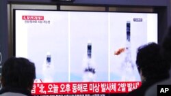 Orang-orang menyaksikan tayangan berita tentang peluncuran misil Korea Utara, dari sebuah layar televisi di Stasiun kereta api Seoul, Korea Selatan, 31 Oktober 2019.