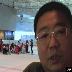 Zhou Jianwei, who's eight-year-old son is a goalie, says ice hockey helps kids learn about teamwork.