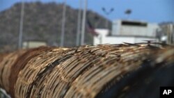 FILE - Barbed wire surrounds the prison camps at the Guantanamo Bay U.S. Naval Base, Cuba in this April 17, 2013 video frame grab reviewed by the U.S. Military.