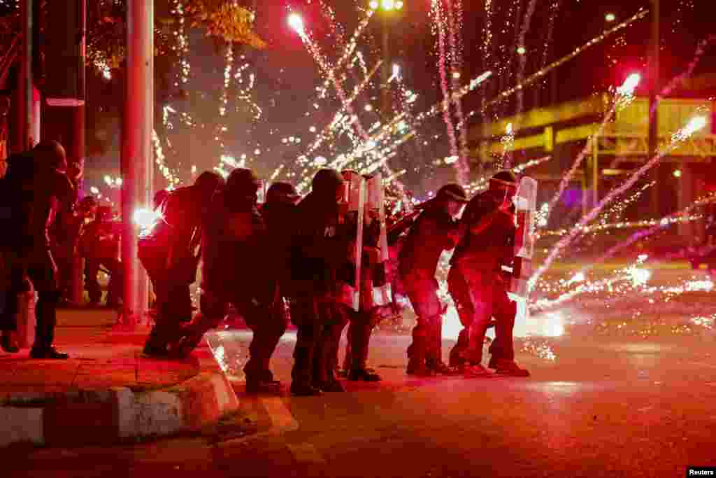 Fireworks thrown by anti-government protesters explode in front of a line of riot police officers during an anti-government protest in Bangkok, Thailand, Sept. 13, 2021.