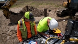FILE - Field geologists conduct ground stability testing at a solar power plant development site located on a former coal mine in Hurley, western Virginia, May 11, 2021.
