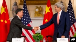 Secretary of State John Kerry, right, shakes hands with China's Vice Premier Wang Yang, left, at U.S. China Strategic and Economic Dialogue (S&ED) at the U.S. State Department in Washington, June 24, 2015.