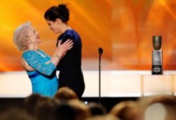 FILE - Sandra Bullock embraces Betty White as she presents her lifetime achievement award at the 16th annual Screen Actors Guild Awards in Los Angeles, California, Jan. 23, 2010.