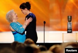 FILE - Sandra Bullock embraces Betty White as she presents her lifetime achievement award at the 16th annual Screen Actors Guild Awards in Los Angeles, California, Jan. 23, 2010.