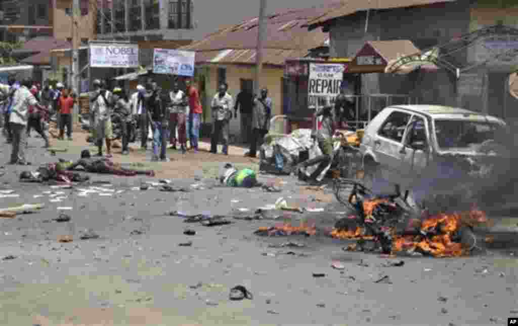 Injured and bodies are seen at the site of a bomb explosion in Kaduna, Nigeria,Thursday, April. 26, 2012.