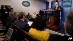 Attorney General Jeff Sessions, right, accompanied by White House press secretary Sean Spicer, second from right, talks to the media during the daily press briefing at the White House in Washington, Monday, March 27, 2017. 