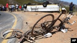 FILE - Two bikes were involved in an accident with a bus that crashed and turned on its roof near the town of Franschhoek, South Africa, March 7, 2015.