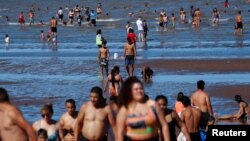 FILE - People try to cool off in the Rio de la Plata River during a heat wave, in Buenos Aires, Argentina, Jan. 9, 2022. 
