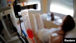 A patient receives chemotherapy treatment for breast cancer at the Antoine-Lacassagne Cancer Center in Nice July 26, 2012. 