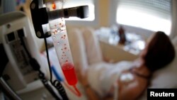 FILE - A patient receives chemotherapy treatment for breast cancer at the Antoine-Lacassagne Cancer Center in Nice, July 26, 2012.