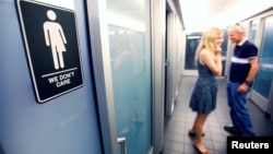 A sign protesting a recent North Carolina law restricting transgender bathroom access adorns the bathroom stalls at the 21C Museum Hotel in Durham, North Carolina, May 3, 2016.