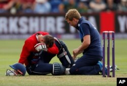 England's Alex Hales is tended to after sustaining an injury to his knee while playing South Africa in Cardiff, June 25, 2017.