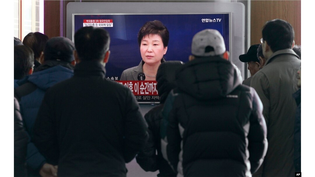 People watch a live broadcast of South Korean President Park Geun-hye addressing the nation at the Seoul Railway Station in Seoul, South Korea, Nov. 29, 2016.