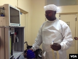 Dr. Michael Koroma inspects a Universal Anesthesia Machine at the Princess Christian Maternity Hospital in Freetown, Sierra Leone, May 27, 2016. (N. deVries/VOA)