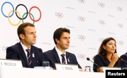 French President Emmanuel Macron, Paris mayor Anne Hidalgo and French slalom canoeist Tony Estanguet attend the briefing of 2024 Olympic Games candidate cities Paris and Los Angeles ahead of final election of 2024 Olympic host city, in Lausanne, Switzerla