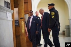 Bill Cosby, second from right, arrives at the Montgomery County Courthouse for his sexual assault trial, June 7, 2017.