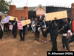 Protesters carry coffins to symbolize the kidnappings and murders of women in Uganda, June 5, 2018.