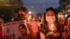 FILE - People hold candles as they take part in an anti-coup night protest at Hledan junction in Yangon, Myanmar, March 14, 2021.