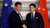 Chinese President Xi Jinping, left, and Italian Prime Minister Giuseppe Conte shake their hands following the signing of a memorandum in support of Beijing's "Belt and Road" initiative, at Rome's Villa Madama, March 23, 2019.