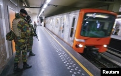 FILE - Belgian soldiers patrol in a subway station in Brussels, Nov. 25, 2015. Brussels' metro re-opened on Wednesday after staying closed for four days following tight security measures linked to the fatal attacks in Paris.