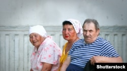 RUSSIA -- Three Russian pensioners on a bench near the entrance of an apartment building. Russia, the city of Volgograd.