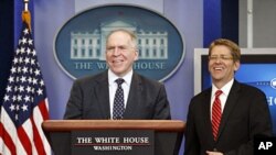 John Brennan (L), assistant to the president for homeland security and counterterrorism, and White House Press Secretary Jay Carney smile as they take the rostrum to speak about the killing of Osama bin Laden at the White House, Washington May 2, 2011