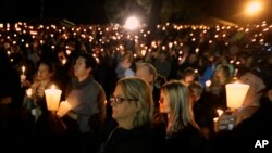 Community members gather for a candlelight vigil for those killed in a shooting at Umpqua Community College in Roseburg, Oregon, Oct. 1, 2015. 