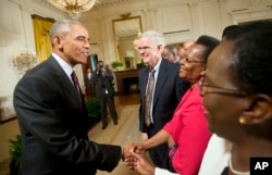 President Barack Obama shakes hands with guests after speaking during a reception in the East Room of the White House in Washington, July 22, 2015. The reception was to celebrate the recent signing into law of the African Growth and Opportunity Act (AGOA)