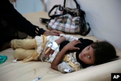 A girl is treated for suspected cholera infection at a hospital in Sanaa, Yemen, Saturday, Jul. 1, 2017.