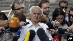 Milos Saljic, the lawyer of Ratko Mladic (C) talks to members of the media in Belgrade, Serbia, May 30, 2011