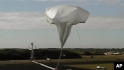 High-altitude balloon carrying saucer-shaped vehicle for NASA is launched to test technology that could be used to land on Mars. (Hawaii, June 2014)
