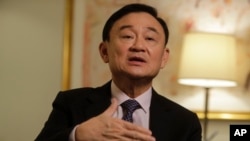 FILE - Thailand's former Prime Minister Thaksin Shinawatra responds to questions during a news interview Wednesday, March 9, 2016, in New York.