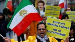 An opponent of Iranian President Hassan Rouhani chants slogans during a protest outside the European Union Council in Brussels, Belgium, Jan. 3, 2018. 