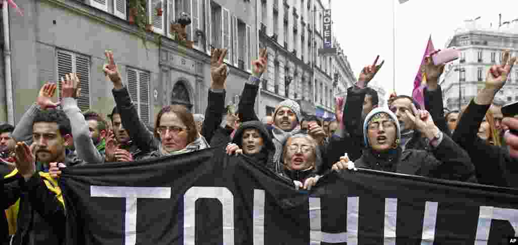 Kurdish people gather in front of the building where three Kurdish women were killed in Paris, France, January 10, 2013. 