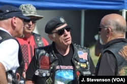 Rolling Thunder executive director Artie Muller, center, is seen with fellow motorcyclists at the Pentagon, in Arlington, Virginia, outside of Washington, May 26, 2019.