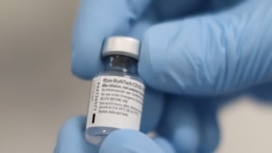FILE PHOTO: A vial of the Pfizer/BioNTech COVID-19 vaccine is seen ahead of being administered at the Royal Victoria Hospital in Belfast