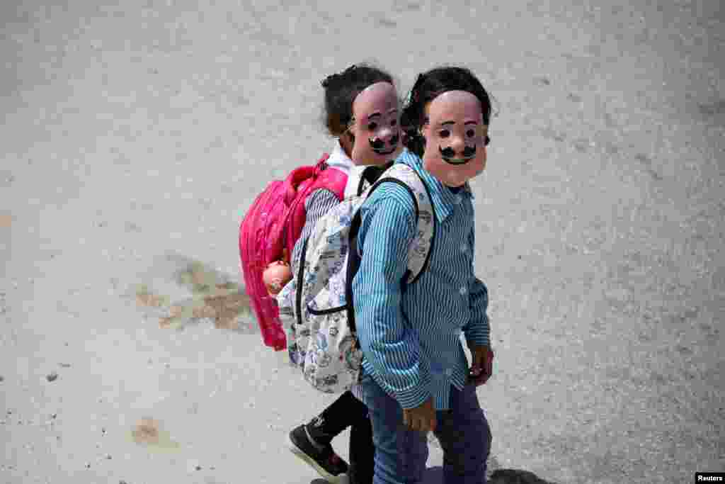 Palestinian students wearing masks return from school in Tubas, Israeli-occupied West Bank.
