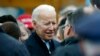 FILE - Former vice president Joe Biden,who just announced his candidacy for the 2020 elections, talks with officials after speaking at a rally in support of striking workers in Boston, April 18, 2019.