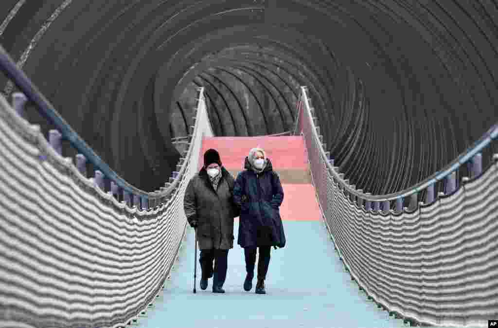 People walk over a bridge during the lockdown in Oberhausen, Germany.