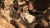 Two artisanal miners digging a pit in a dry riverbed in Karamoja, Uganda, on March 2, 2014. (Hilary Heuler for VOA)