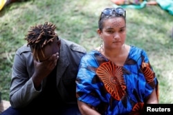 Attendees react during a eulogy for Kenyan author and LGBT activist Kenneth Binyavanga Wainaina, during a memorial service at the Nairobi national museum in Nairobi, Kenya, May 30, 2019.