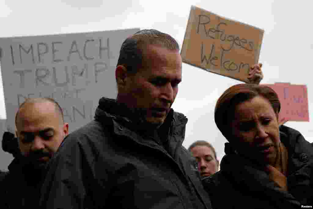 Iraqi immigrant Hameed Darwish stands with Congresswoman Nydia Velazquez, right, after being released at John F. Kennedy International Airport in Queens, New York, Jan, 28, 2017.