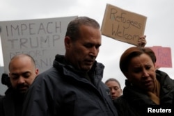 Iraqi immigrant Hameed Darwish stands with Congresswoman Nydia Velazquez, right, after being released at John F. Kennedy International Airport in Queens, New York, Jan, 28, 2017.