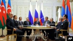 Russia then-President Dmitry Medvedev, center, Armenian President Serge Sarkisian, second right, and Azerbaijan's President Ilham Aliyev, second left, meet in the presidential palace of the Kremlin in Kazan, Russia, Friday, June 24, 2011.