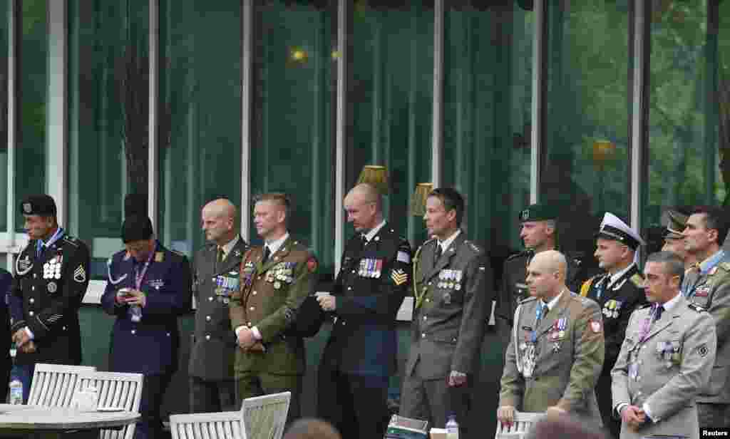 Military personnel wait outside as leaders from the U.S., France, Italy, Germany, the United Kingdom and Ukraine participate in a meeting on the situation in Ukraine at the NATO Summit at the Celtic Manor Resort in Newport, Wales, Sept. 4, 2014. 